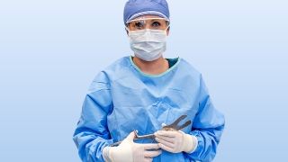 Surgical Technician holding tools for surgery