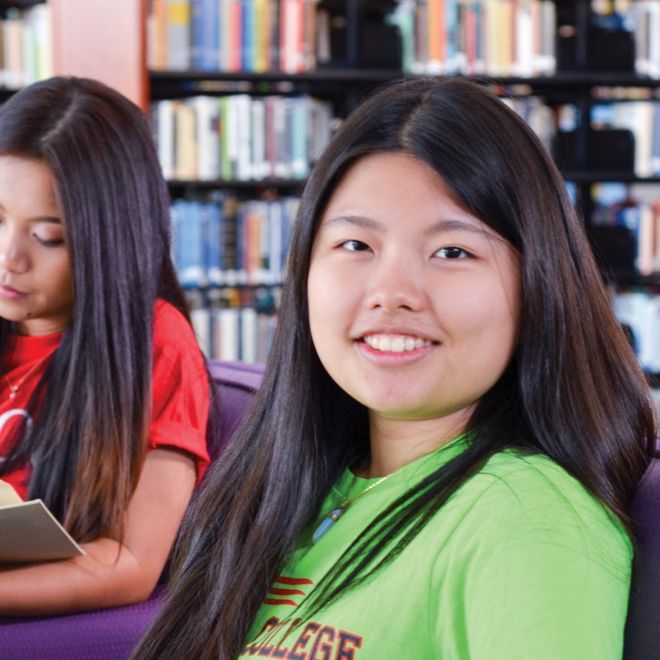 Two female students in the library.