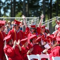 Group of Olympic College students in red regalia at graduation