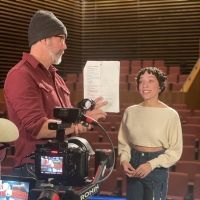 Student practicing lines with producer while filming