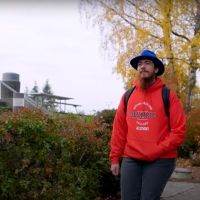 Students in red OC sweatshirt walking outdoors