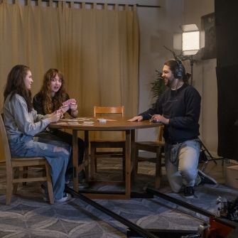 Filmmaking students filming a scene on sound stage