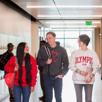 Four students in a hallway together. 
