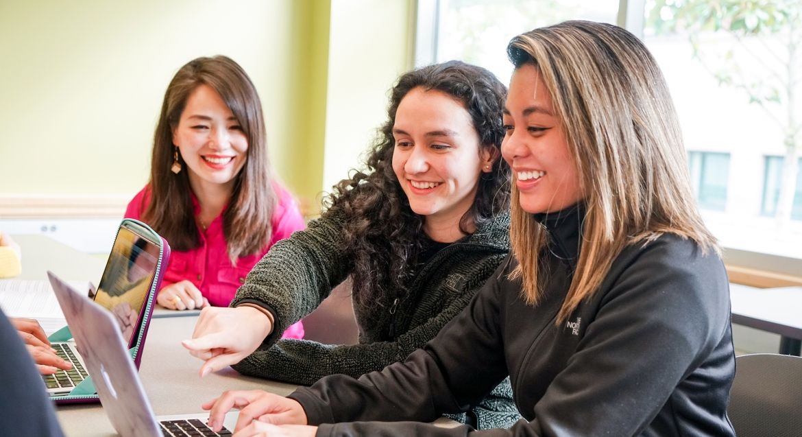 Three female students with laptops