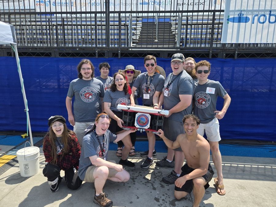 STEM students with robotic submarine at competition