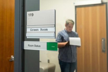 Student in green room.