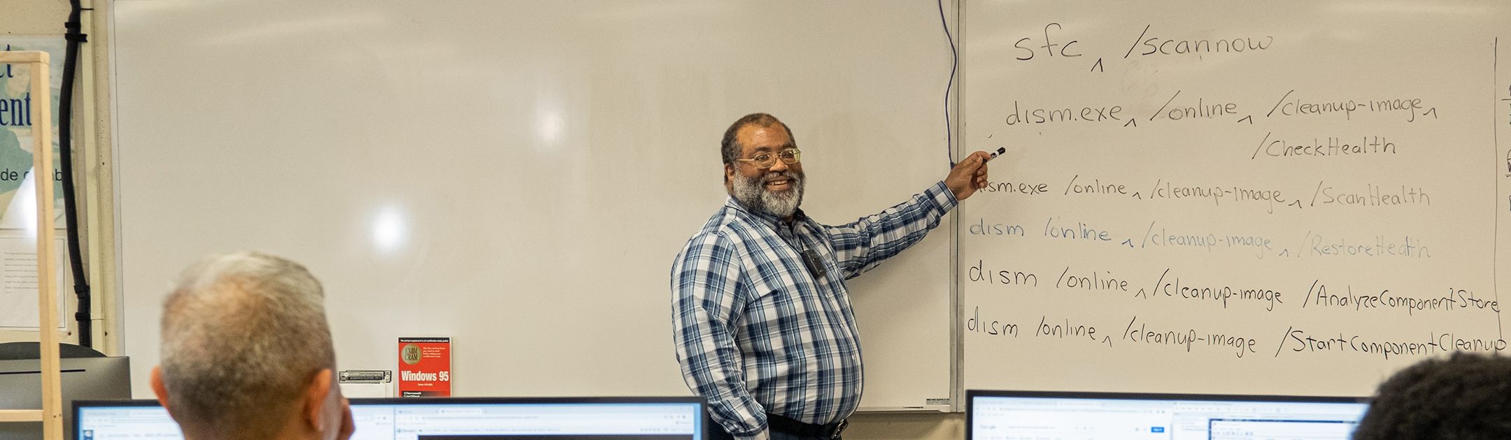 OC Professor Kevin Blackwell teaching a class, with two students in the foreground