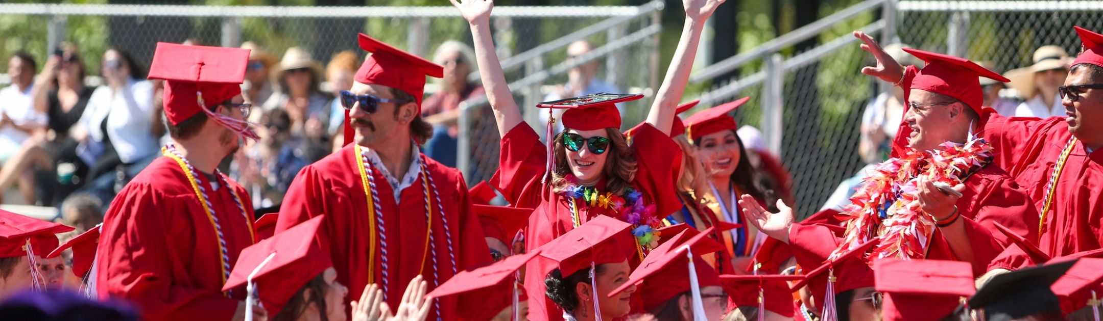 Group of Olympic College students in red regalia at graduation