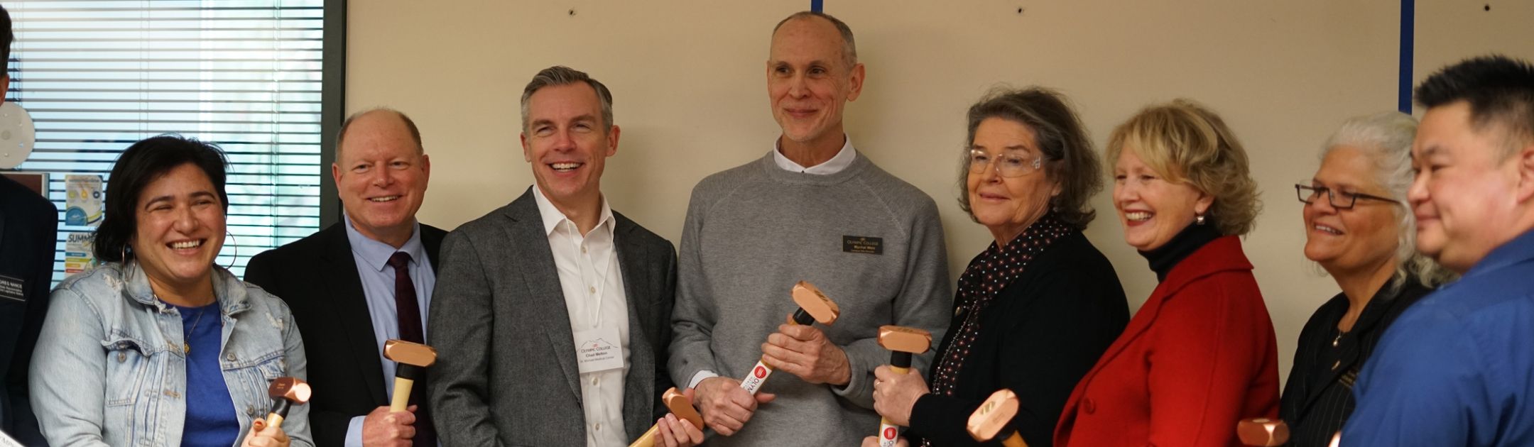 Speakers gather with commemorative sledgehammers.