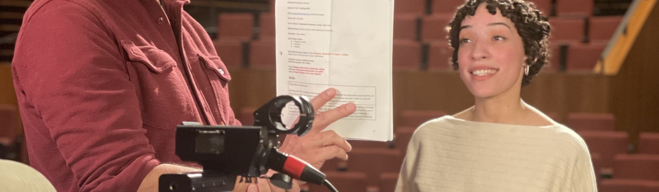 Student practicing lines with producer while filming
