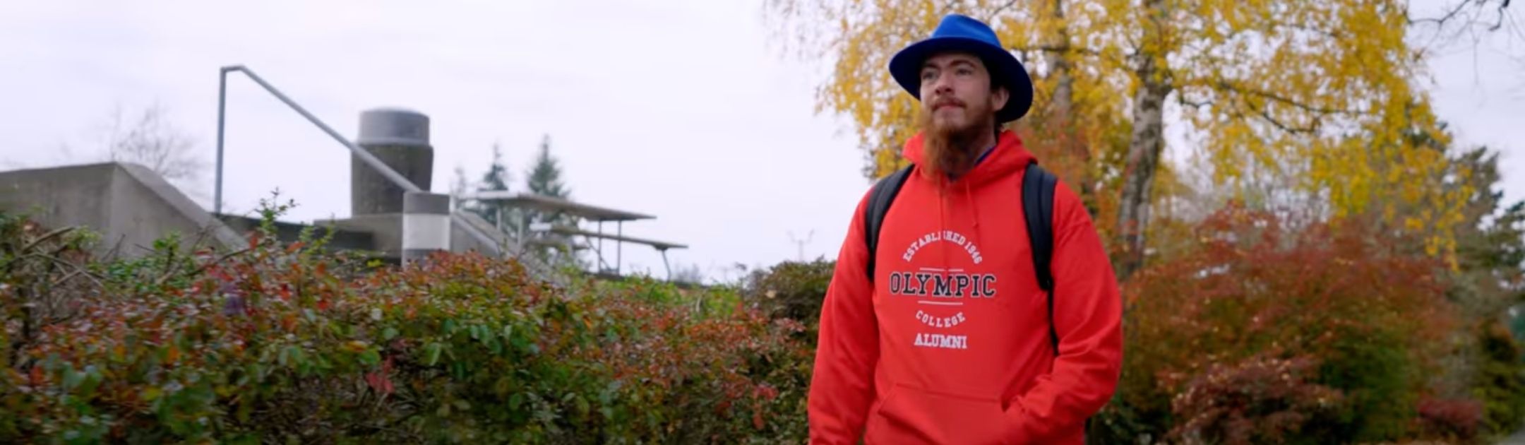 Students in red OC sweatshirt walking outdoors