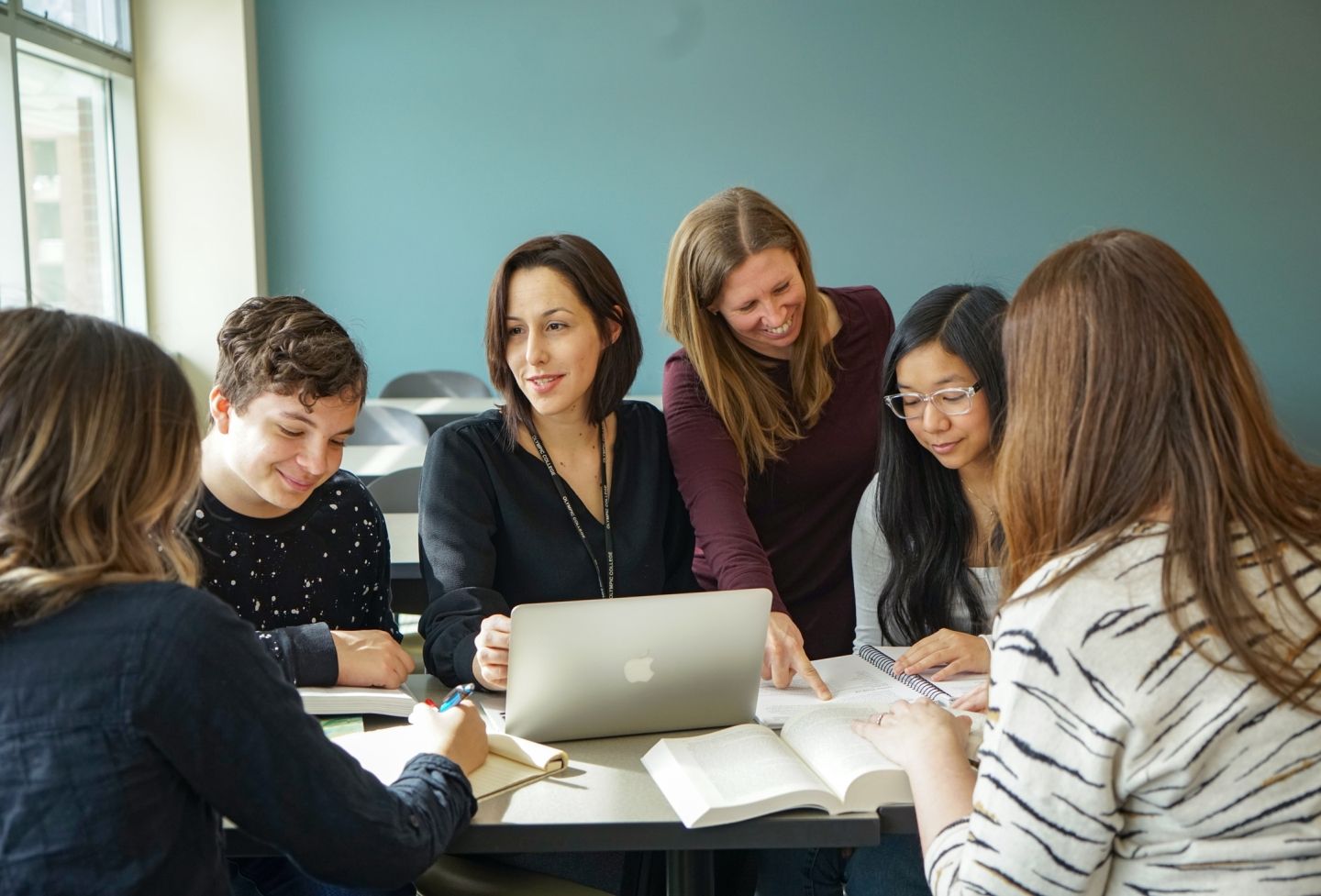 Faculty with students in classroom.