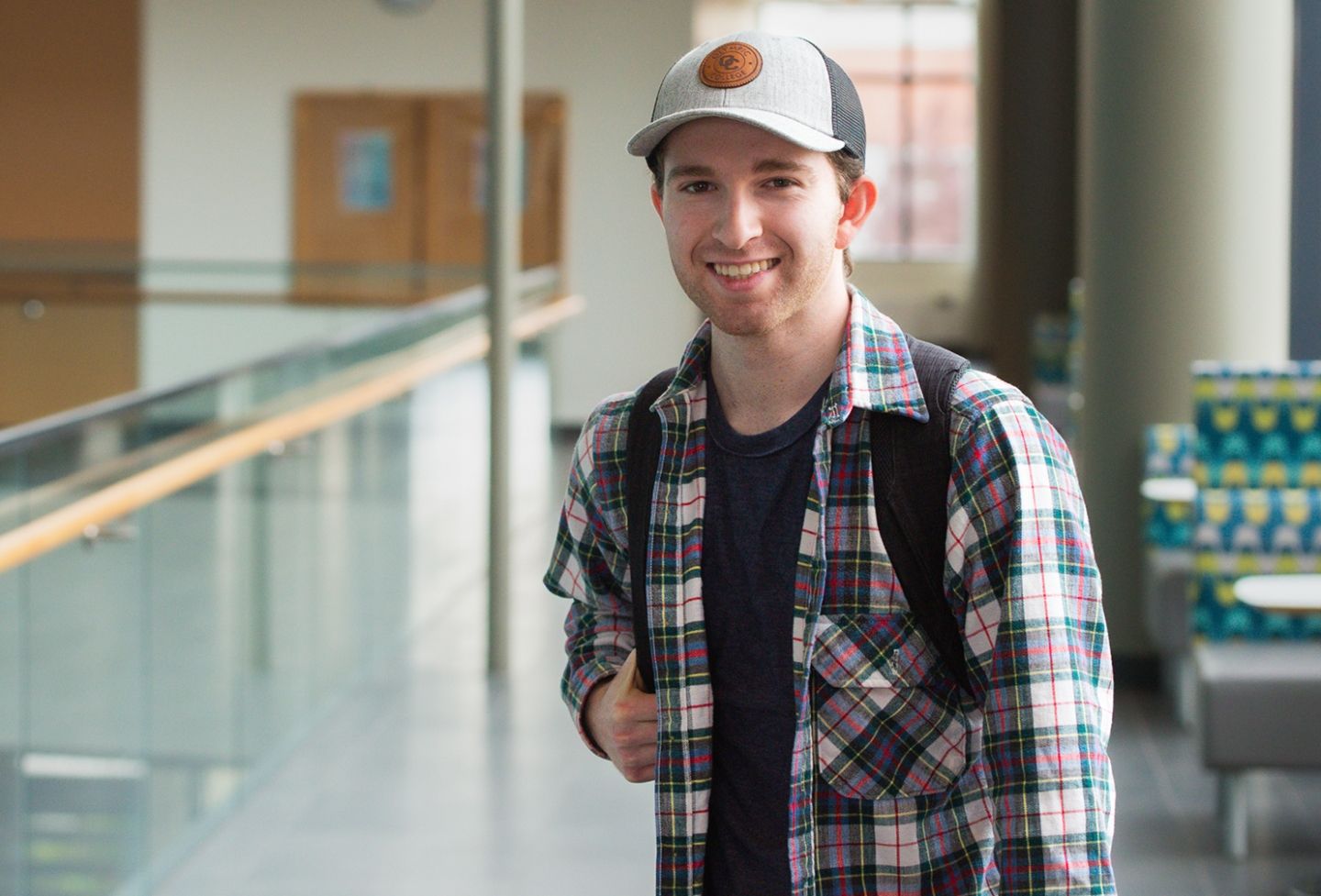 Olympic College Student posing with backpack slung over shoulder