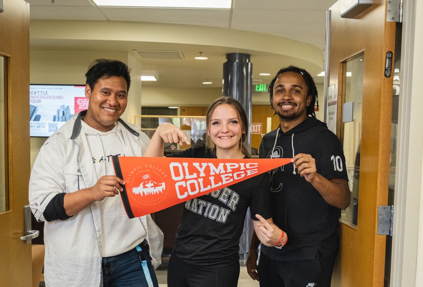 Three Students with Banner